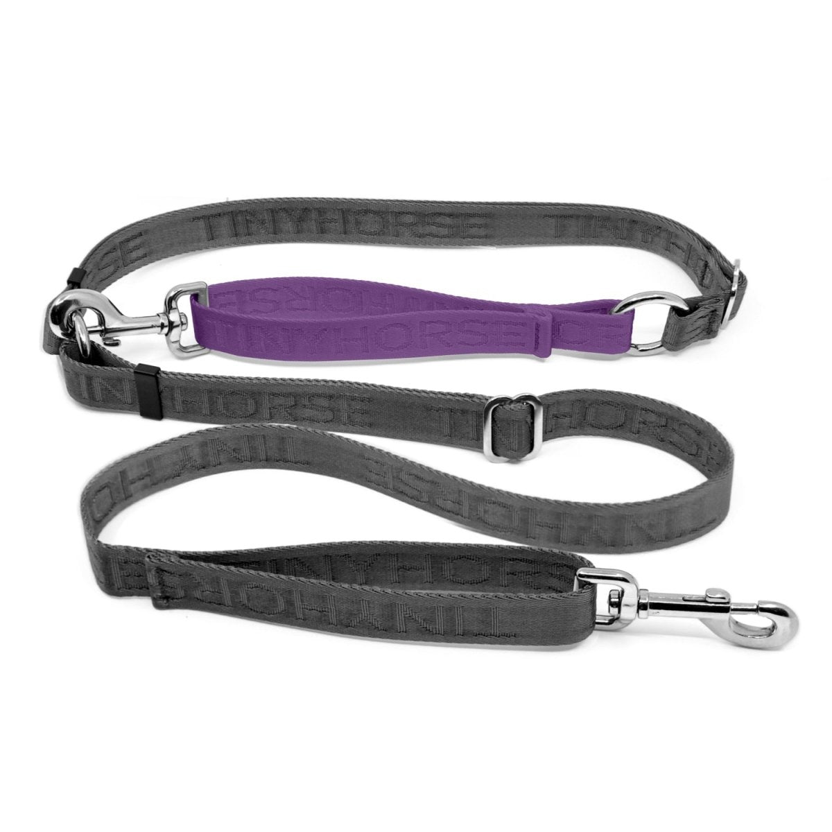 Adjustable hands-free dog leash with traffic handle. Grey with a lilac colour accent in front of the hips. Attach more dogs using the rings sewn into the waist. Made of nylon embossed with “Tinyhorse.”